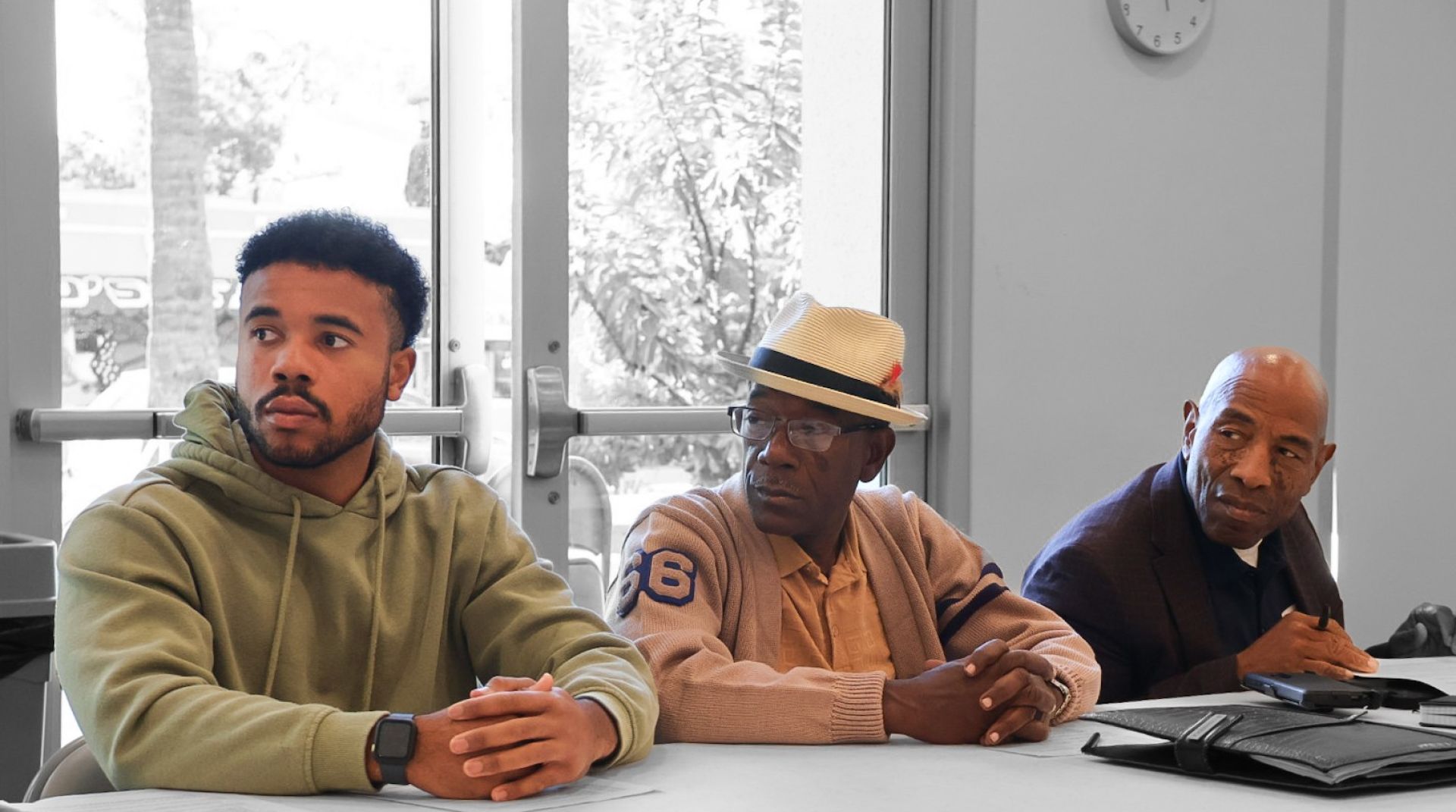 Two friends smiling and embracing on a sunny day outdoors on a road.