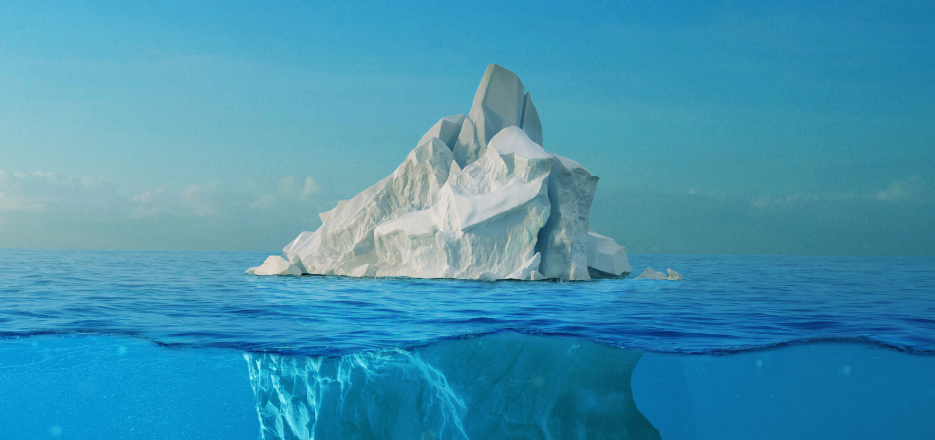 Stunning aerial shot capturing a large iceberg floating in turquoise waters.