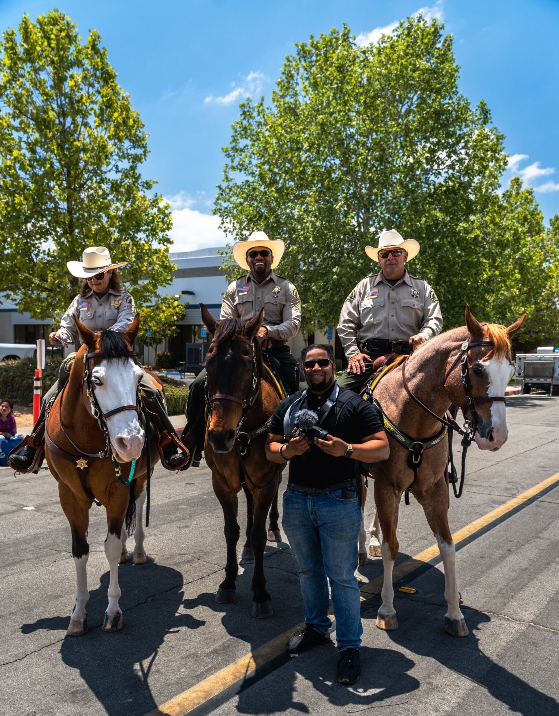 Smiling volunteer seated with boxes labeled food and medicine in a van.