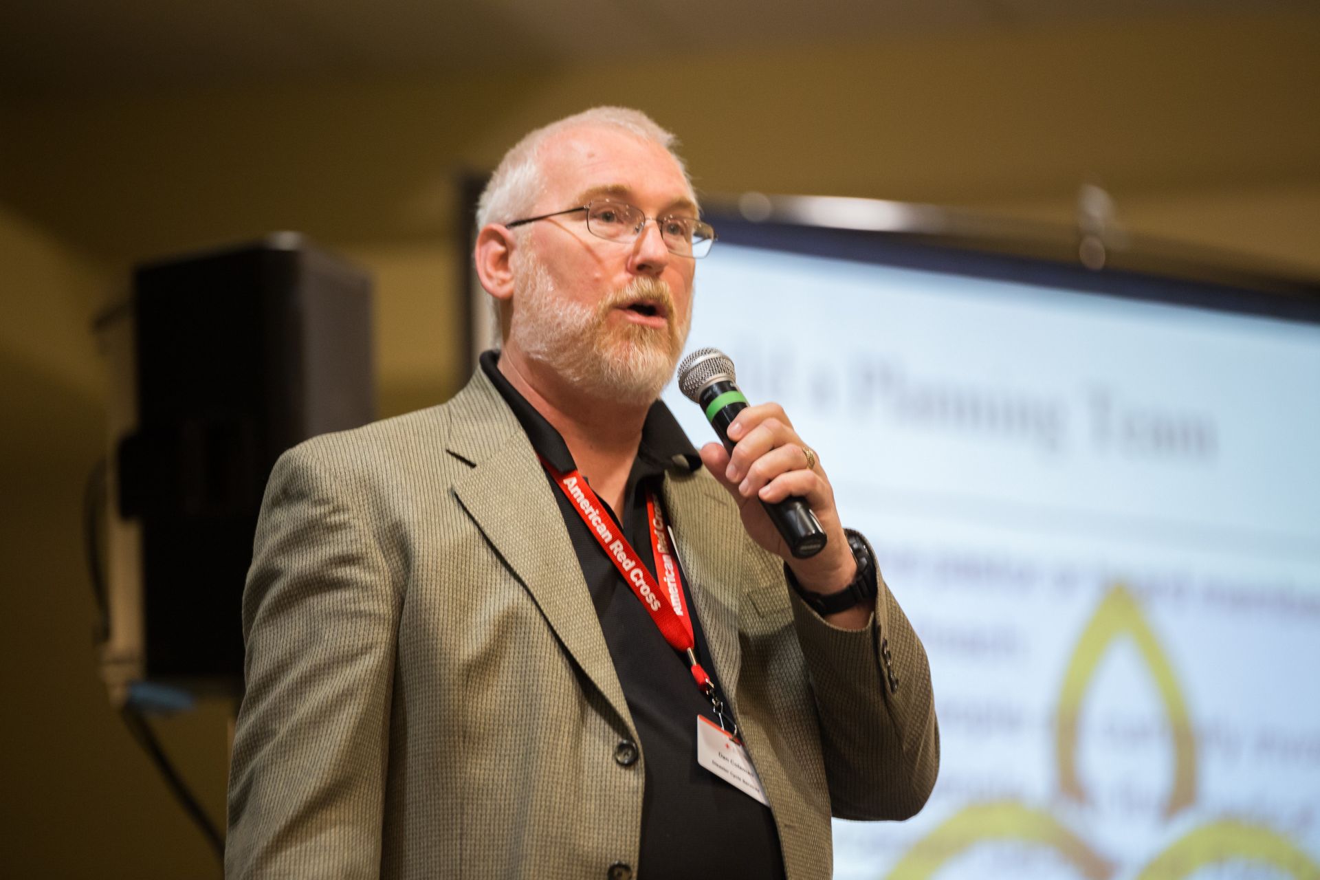 A priest delivers a sermon inside a beautifully lit church, standing at an altar.