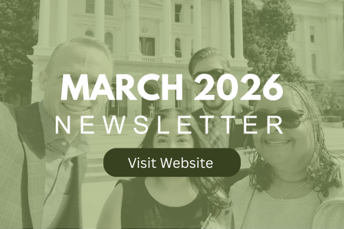 A red fire extinguisher mounted on a plain white wall for emergency safety.