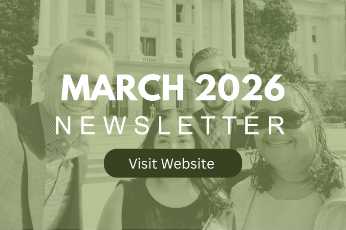 A red fire extinguisher mounted on a plain white wall for emergency safety.